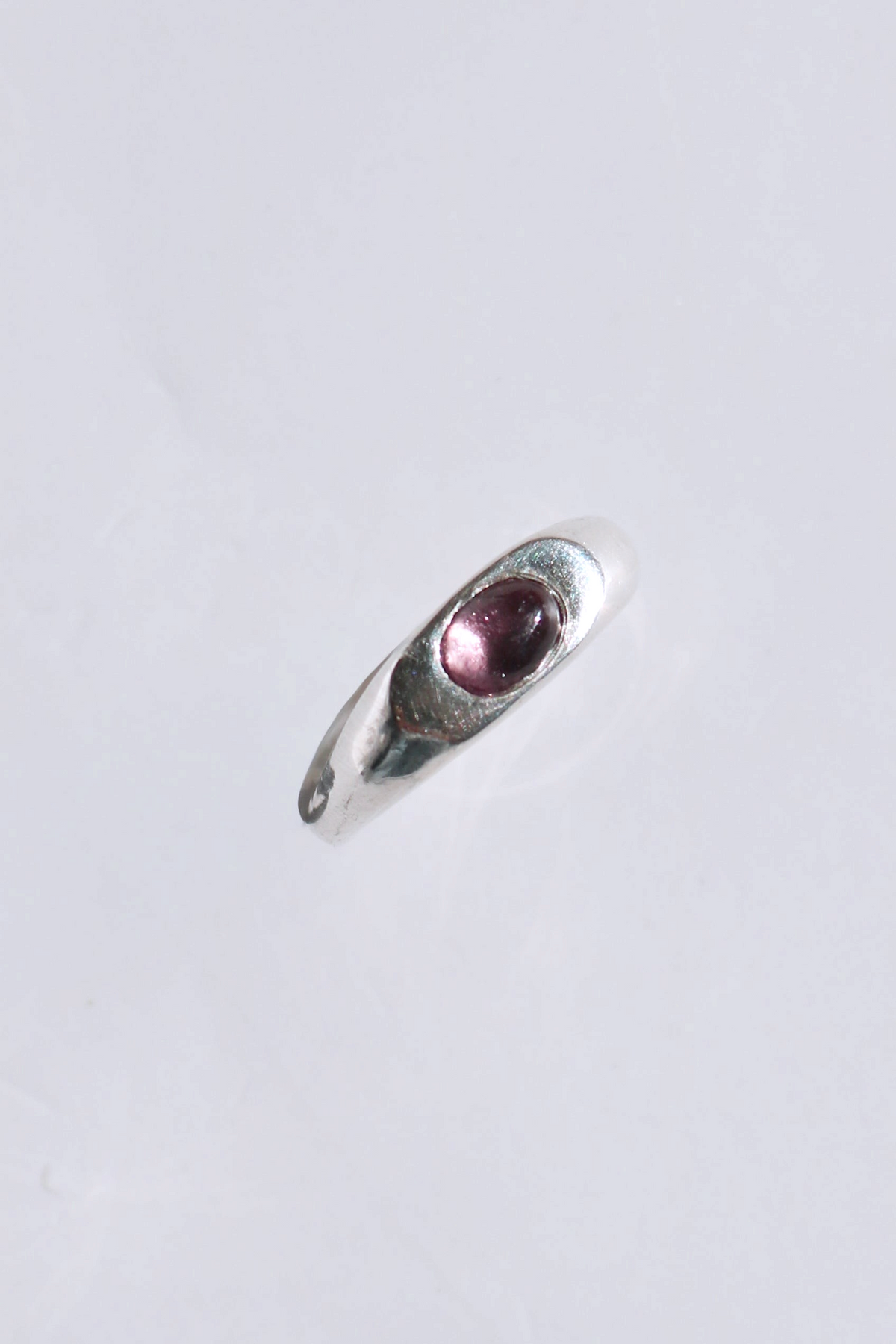 Odissea Aurelia ring in polished sterling silver with a smooth domed band and a single cabochon tourmaline stone.