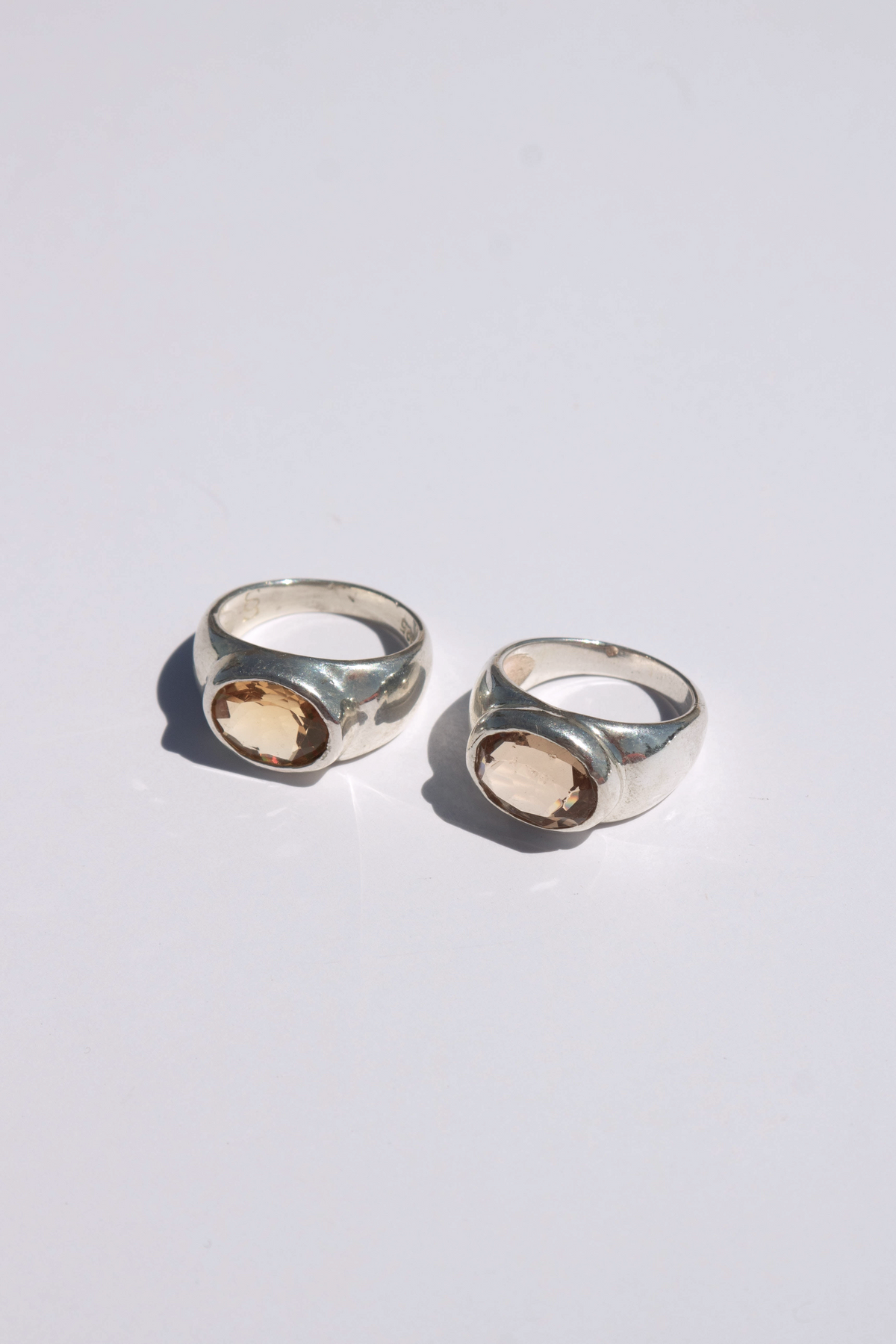 Odissea Milano rings in white gold with oval faceted citrine stones on a white background
