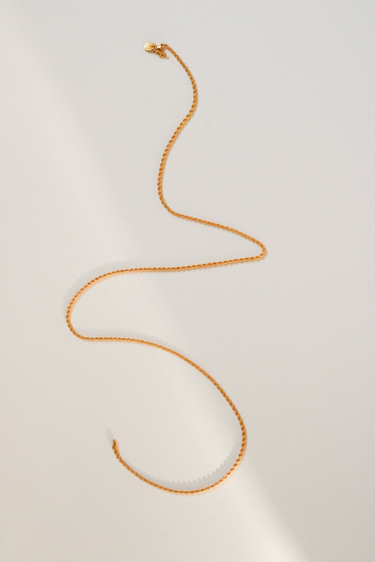 Odissea 14k gold rope chain necklace with a delicate 1.5mm twisted design on a clean white background