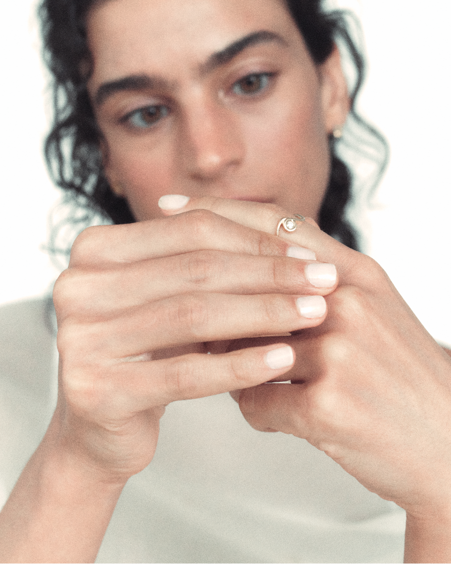 Woman holding her hands to her face with a neutral background