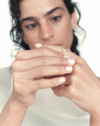 Woman holding her hands to her face with a neutral background