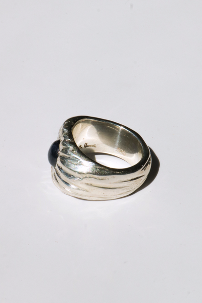 Odissea Dean Ring featuring a chunky sculptural sterling silver band set with a dark blue star sapphire gemstone.