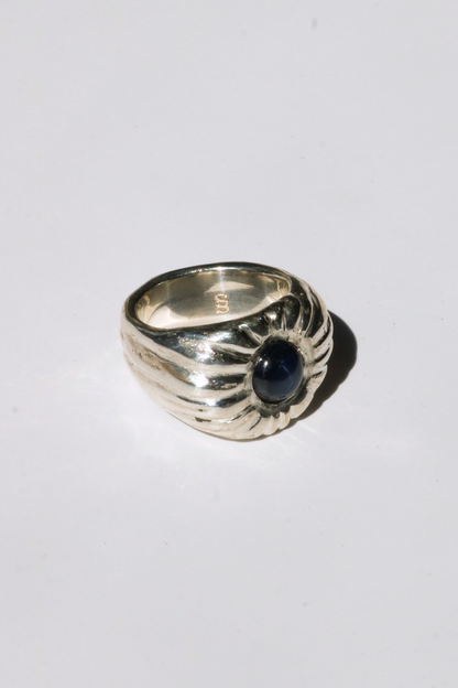 Odissea Dean ring featuring a chunky sculptural silver band with a central blue star sapphire gemstone
