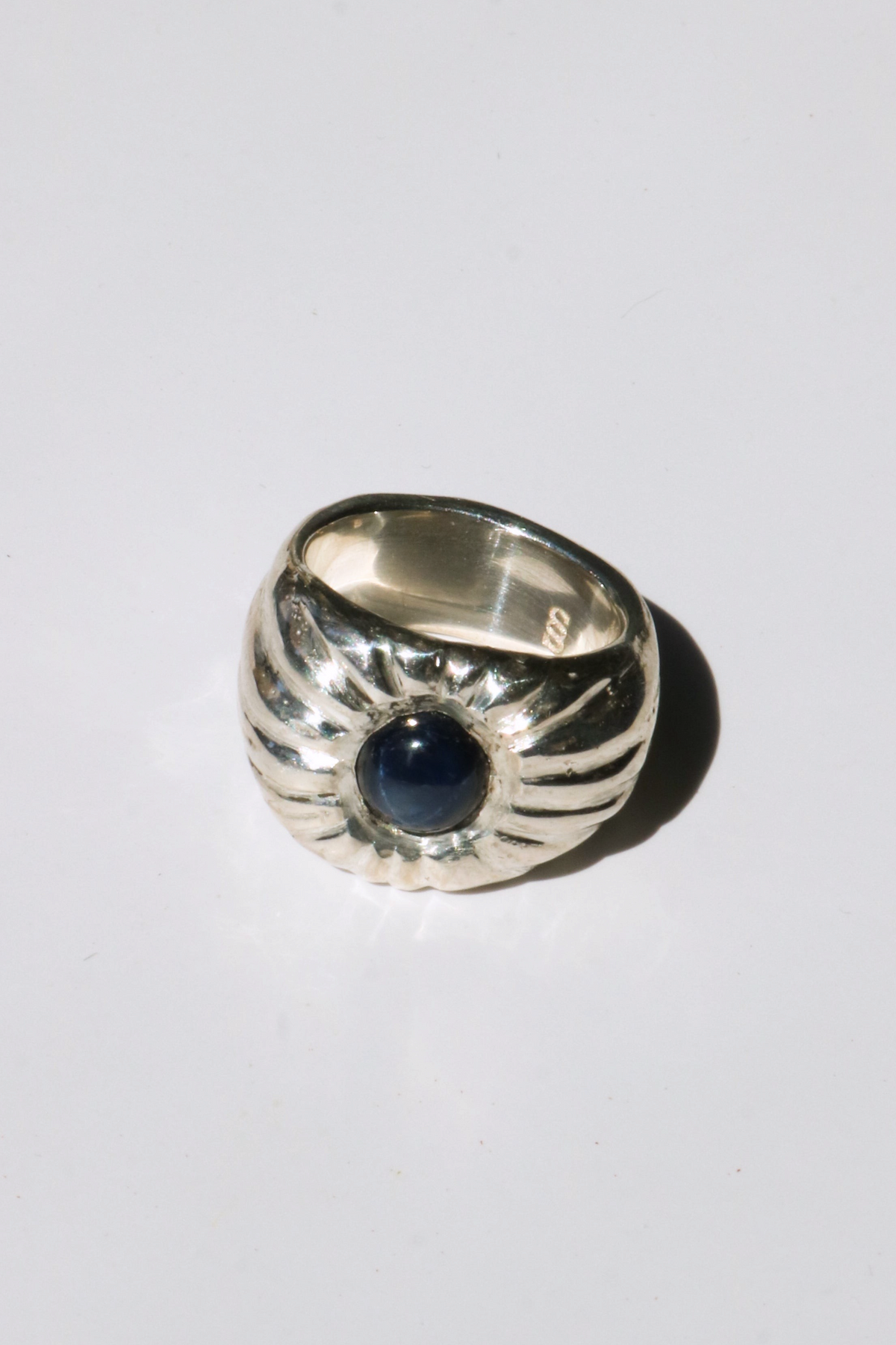 Odissea Dean ring featuring a chunky sculptural silver band with a central deep blue star sapphire gemstone