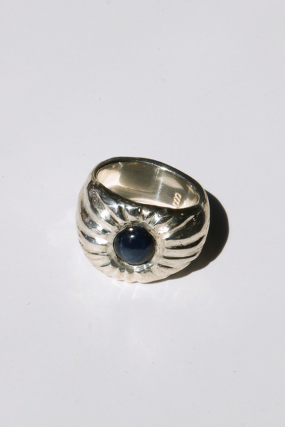 Odissea Dean ring featuring a chunky sculptural silver band with a central deep blue star sapphire gemstone