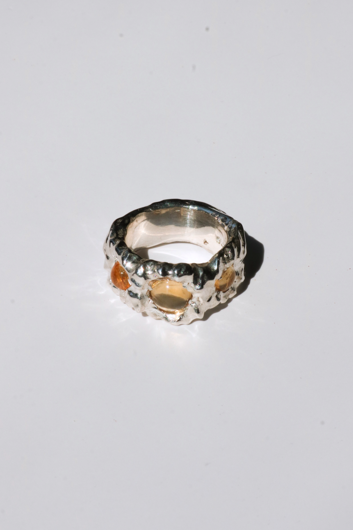 Odissea Isidore ring featuring a chunky, sculptural silver band set with warm, translucent citrine gemstones.