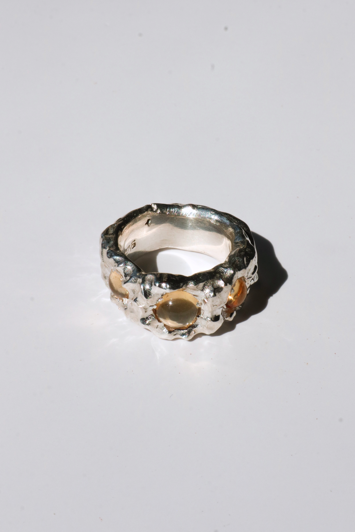 Odissea Isidore ring featuring a chunky, sculptural silver band with embedded round citrine stones.