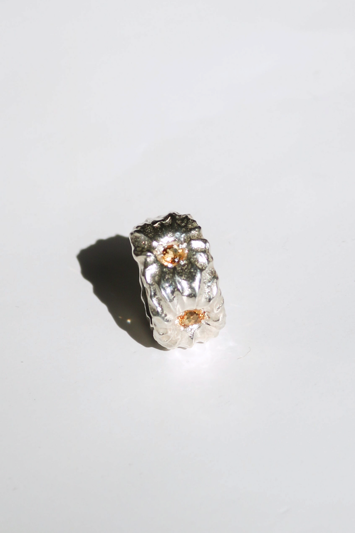 Odissea Willow Ring featuring a chunky, sculptural silver band set with two sparkling citrine stones.