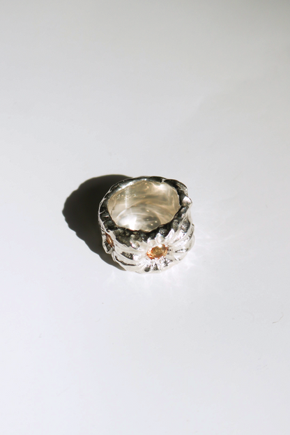 Odissea Willow Ring featuring a chunky, sculptural silver band with a small, warm citrine gemstone inlay.